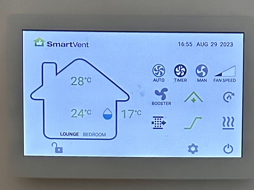 A SmartVent home ventilation controller on a wall, showing the lounge and bedroom temperatures and the fan settings