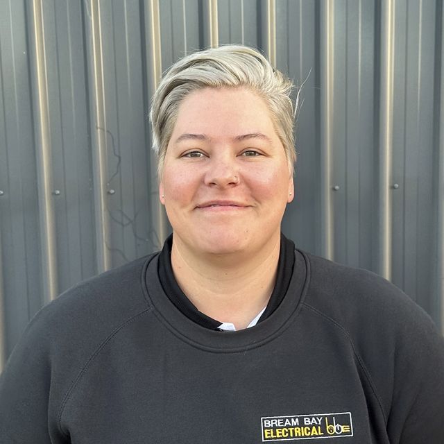 Harmony from Bream Bay Electrical in a black company jumper