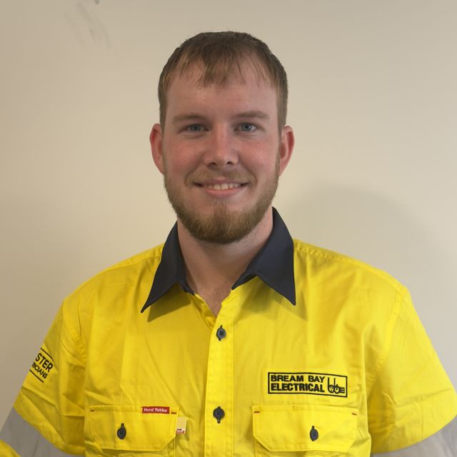 Jaxon Maunder from Bream Bay Electrical in a yellow company work shirt