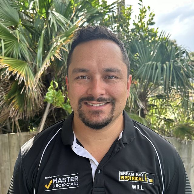Will Campbell, director of Bream Bay Electrical, in a black company polo shirt